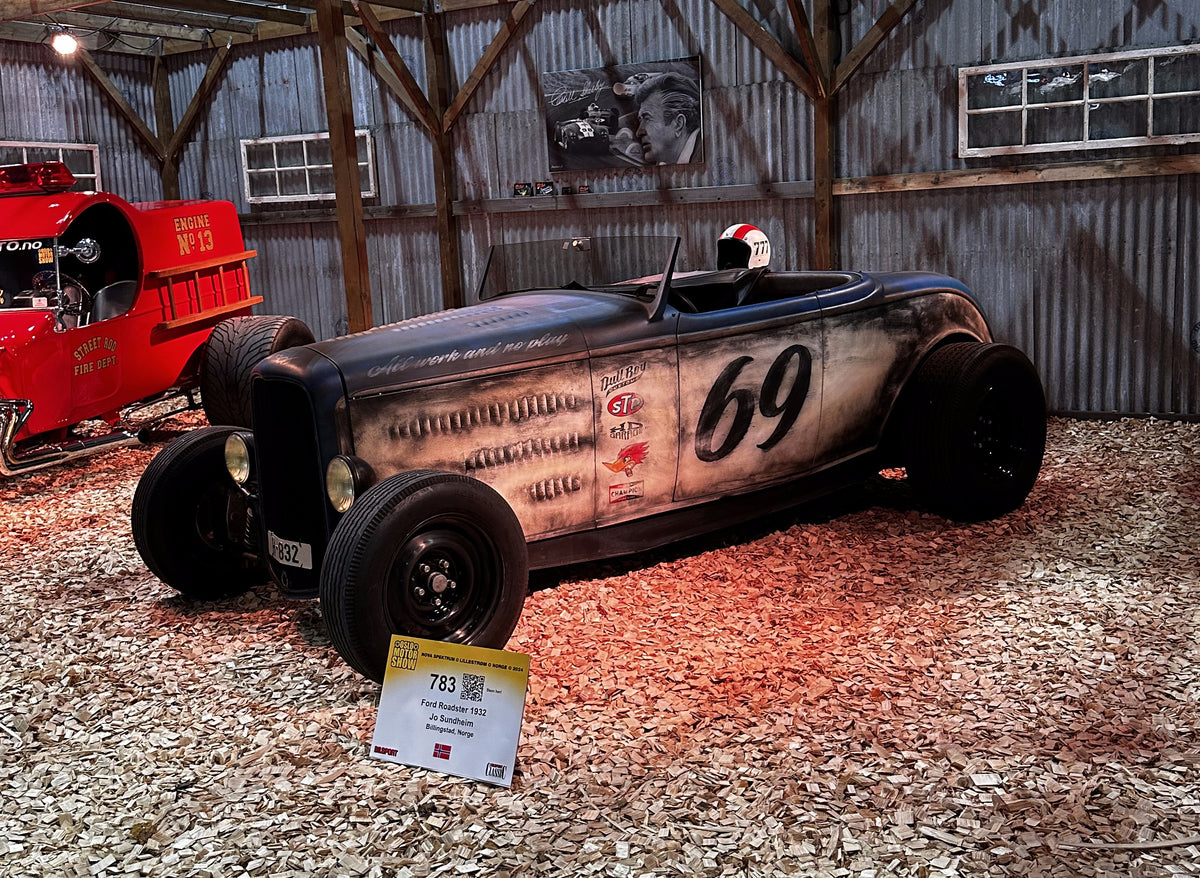 Custom-painted motorcycle tank with hand-applied lettering and graphics